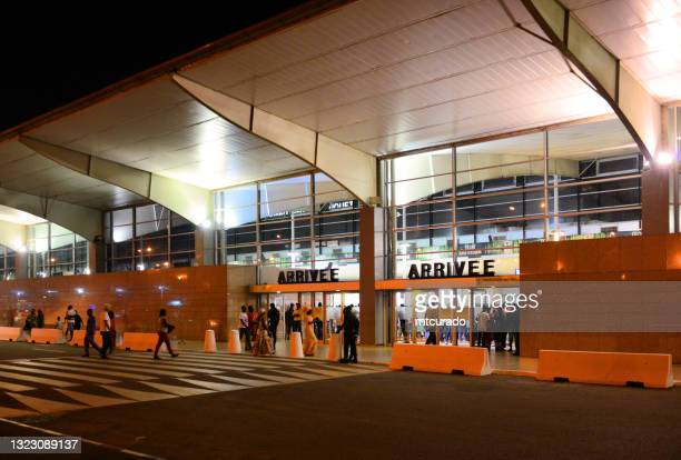 Abidjan, Ivory Coast / Côte d'Ivoire: Félix-Houphouët-Boigny International Airport aka Port Bouët Airport - main terminal, people outside the arrivals hall (IATA: ABJ, ICAO: DIAP).